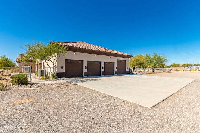 view of home's exterior featuring central AC and a garage