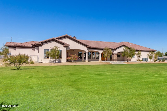 back of property featuring a lawn and central AC unit