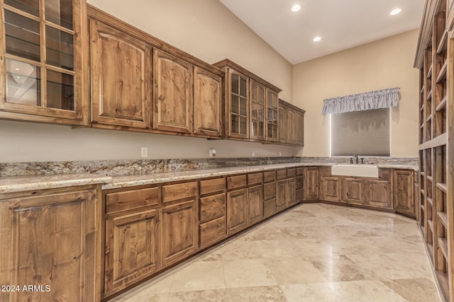 kitchen with sink and light stone counters