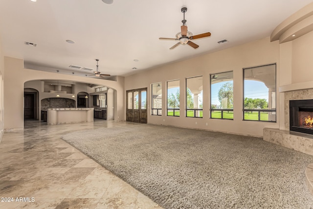 unfurnished living room featuring ceiling fan