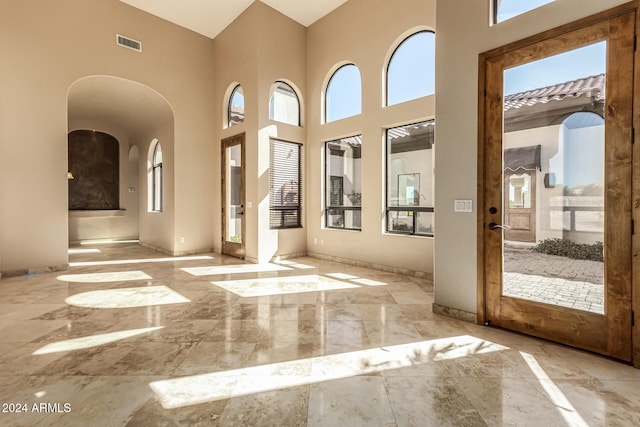 doorway to outside featuring a high ceiling