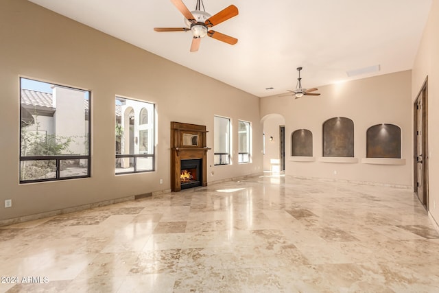 unfurnished living room with ceiling fan