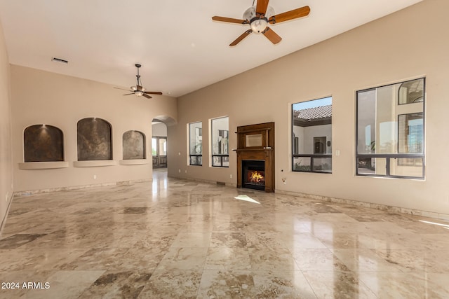 unfurnished living room featuring ceiling fan