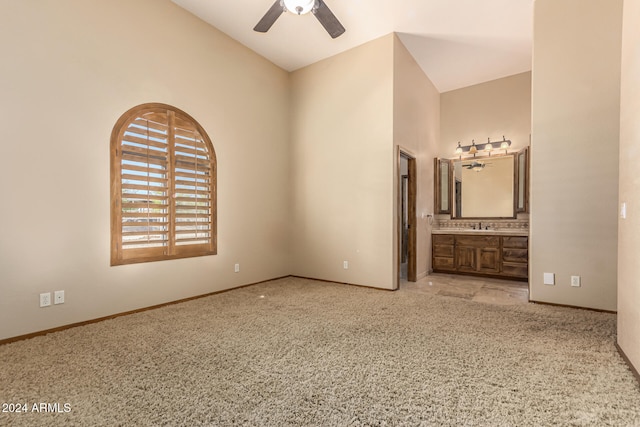 unfurnished bedroom with sink, ceiling fan, light colored carpet, and ensuite bath