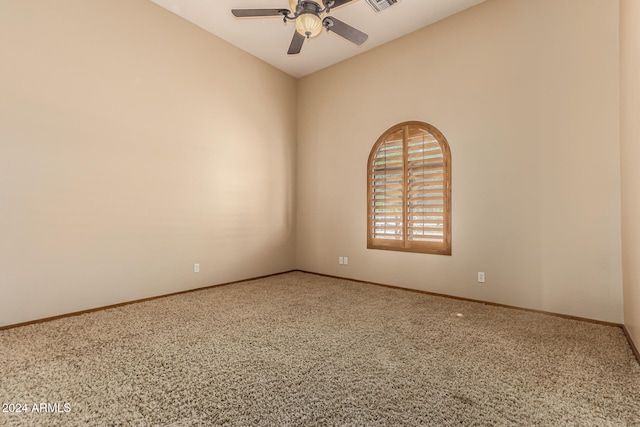 carpeted spare room with ceiling fan