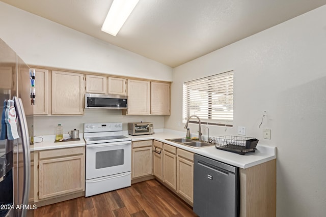 kitchen featuring light brown cabinets, sink, lofted ceiling, and stainless steel appliances