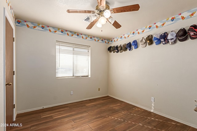 spare room featuring ceiling fan and dark wood-type flooring