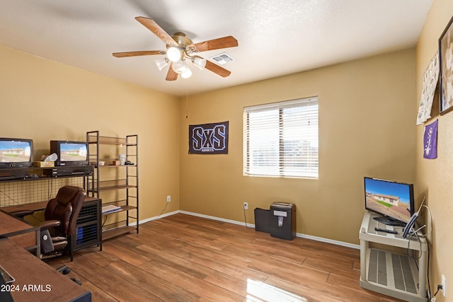 office with hardwood / wood-style flooring and ceiling fan