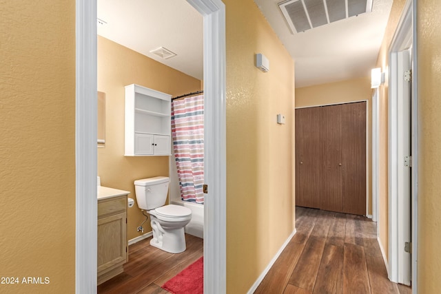 corridor with dark hardwood / wood-style flooring