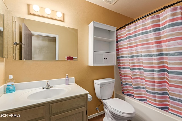 full bathroom with shower / tub combo with curtain, vanity, a textured ceiling, and toilet