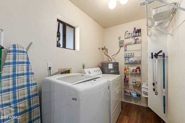 laundry area featuring water heater, dark hardwood / wood-style flooring, and independent washer and dryer