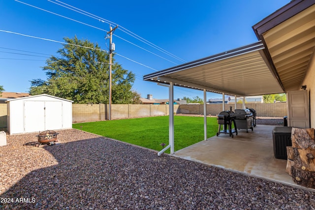 view of yard featuring a patio area and a storage shed