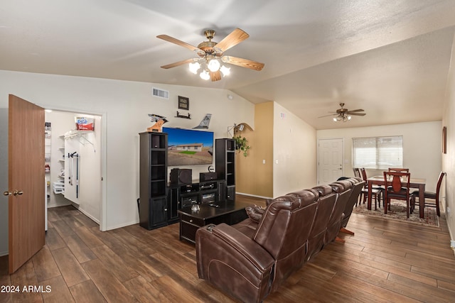 living room with ceiling fan, dark hardwood / wood-style flooring, and lofted ceiling