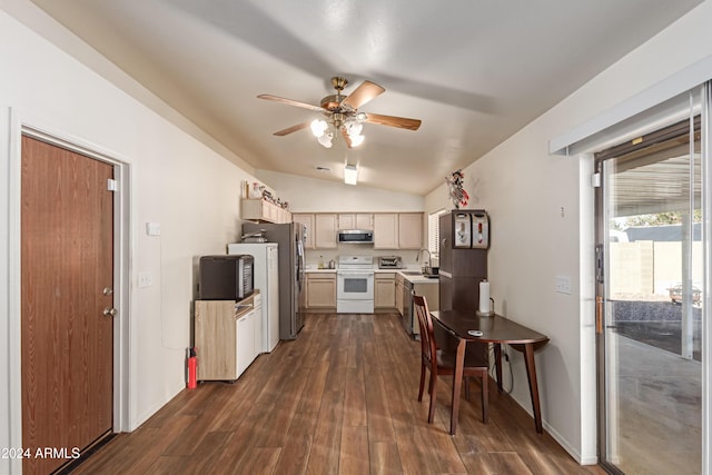 kitchen featuring light brown cabinetry, stainless steel appliances, vaulted ceiling, dark wood-type flooring, and sink