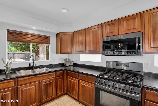 941 E Stirrup Ln, San Tan Valley, AZ 85143 - kitchen with stainless steel appliances, dark countertops, brown cabinets, light tile patterned floors, and recessed lighting