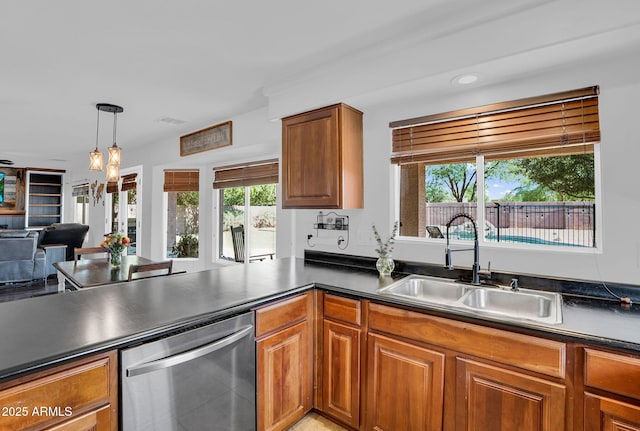 941 E Stirrup Ln, San Tan Valley, AZ 85143 - kitchen featuring stainless steel dishwasher, dark countertops, brown cabinetry, and recessed lighting