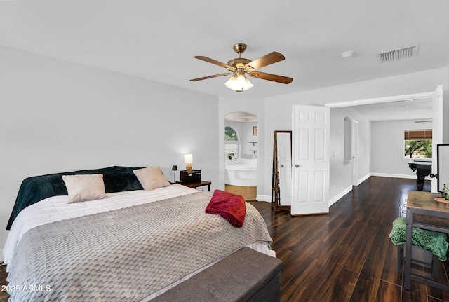 941 E Stirrup Ln, San Tan Valley, AZ 85143 - bedroom featuring arched walkways, wood finished floors, ceiling fan, and connected bathroom