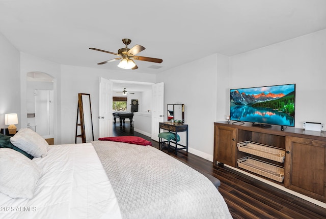 941 E Stirrup Ln, San Tan Valley, AZ 85143 - bedroom with dark wood-type flooring, arched walkways, and ceiling fan