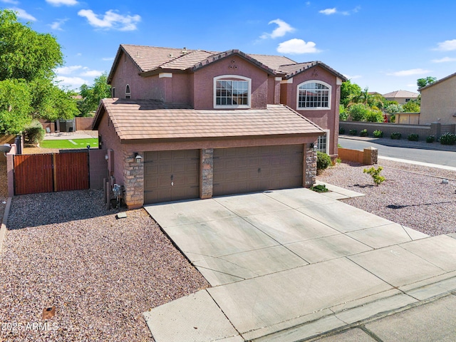 941 E Stirrup Ln, San Tan Valley, AZ 85143 - view of front of house featuring stucco siding, driveway, stone siding, a garage, and a tiled roof