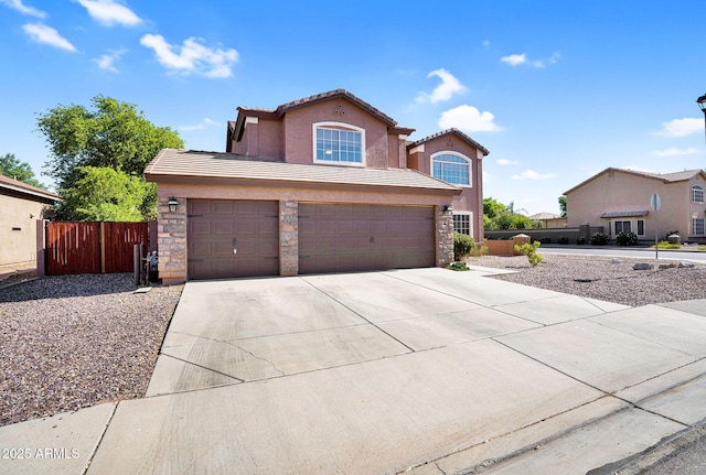 941 E Stirrup Ln, San Tan Valley, AZ 85143 - view of front facade with concrete driveway, a tile roof, stucco siding, an attached garage, and stone siding