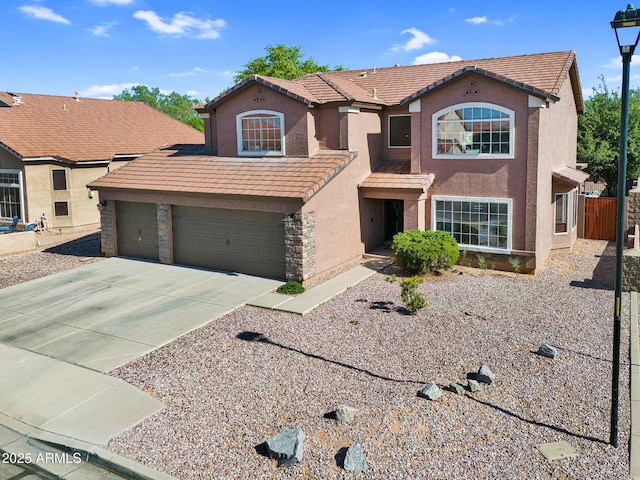 941 E Stirrup Ln, San Tan Valley, AZ 85143 - view of front facade featuring a tile roof, stucco siding, concrete driveway, and a garage