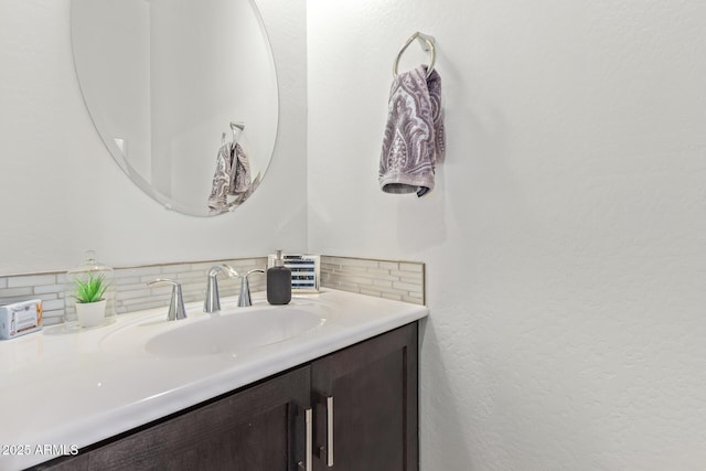 bathroom featuring vanity and tasteful backsplash
