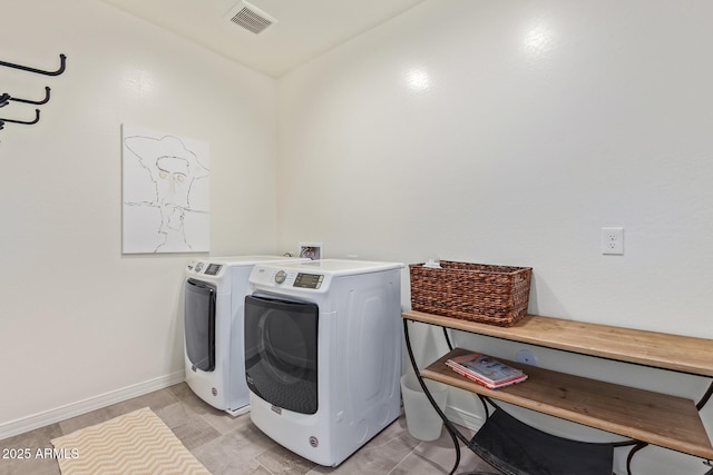 laundry room featuring visible vents, baseboards, laundry area, and washing machine and dryer