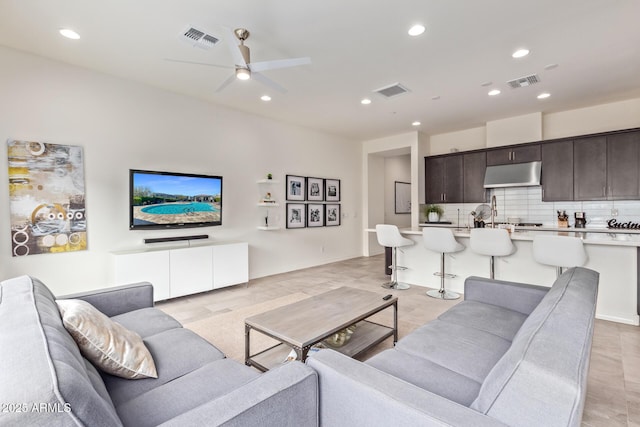 living room with visible vents, a ceiling fan, and recessed lighting