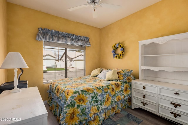 bedroom with ceiling fan and dark wood-style flooring