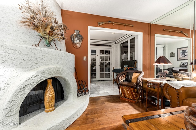 interior space featuring a high end fireplace, a textured ceiling, and hardwood / wood-style flooring