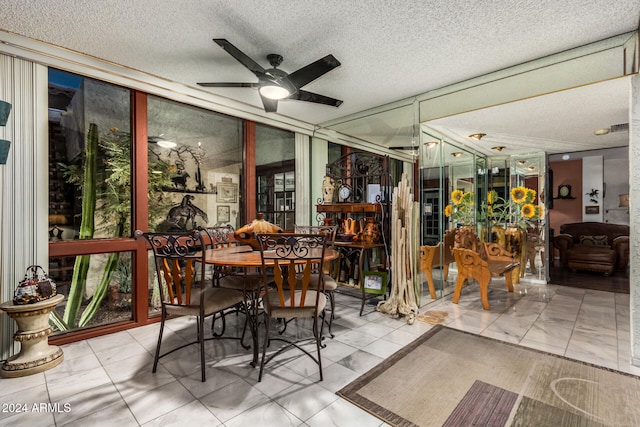 sunroom / solarium featuring ceiling fan