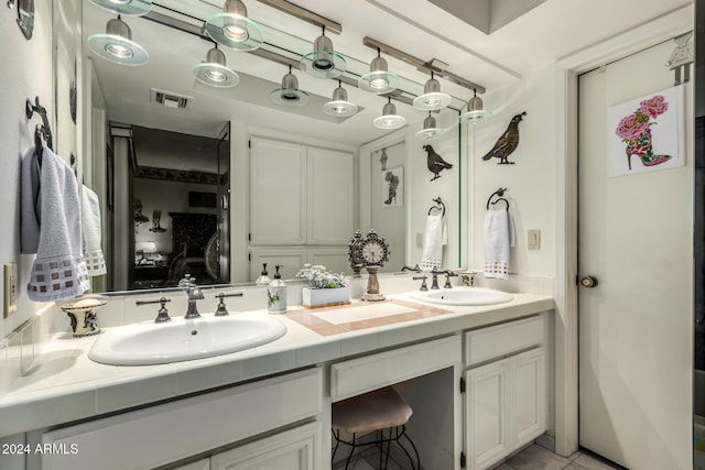 bathroom with tile patterned flooring and vanity