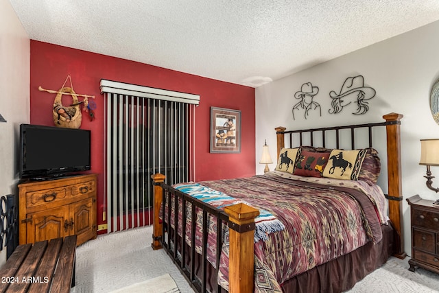 carpeted bedroom featuring a textured ceiling