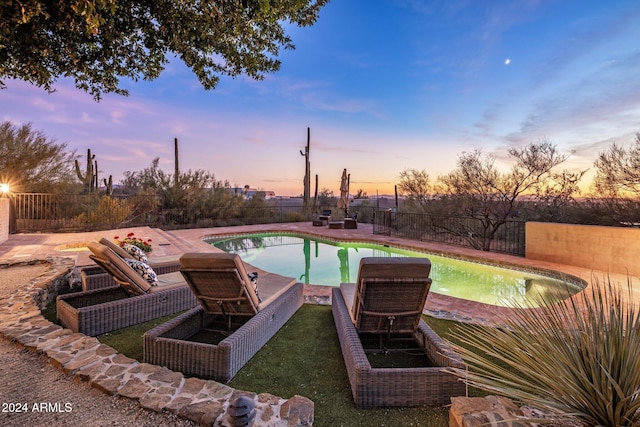 view of pool at dusk