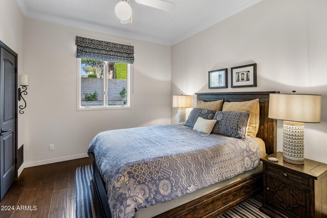 bedroom with crown molding, dark wood-type flooring, and ceiling fan