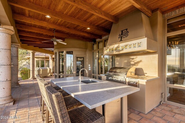 view of patio / terrace featuring ceiling fan, an outdoor kitchen, sink, and grilling area