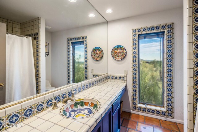 bathroom with vanity, curtained shower, and tile patterned floors