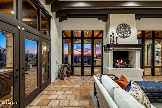 living room with french doors and beamed ceiling