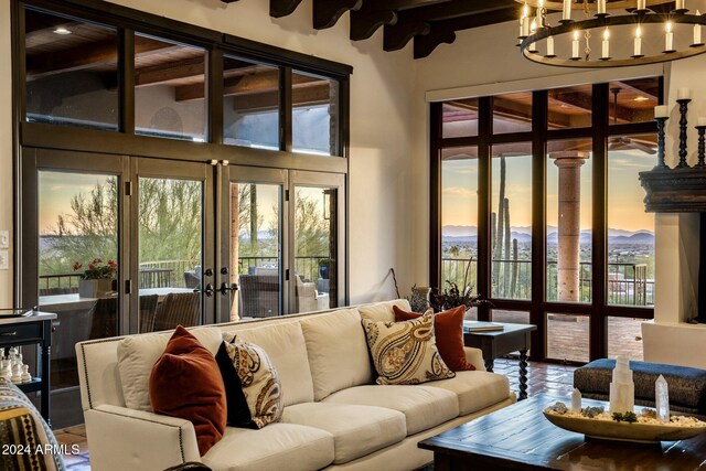 living room featuring a notable chandelier and french doors