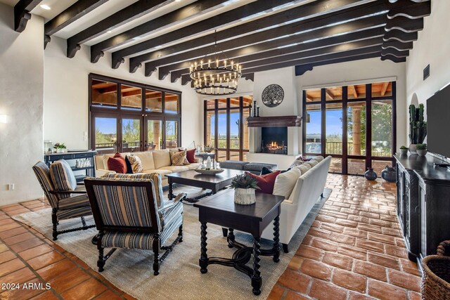 living room featuring beam ceiling and a chandelier