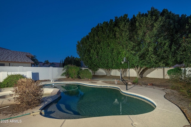 view of pool with a fenced backyard, a diving board, and a fenced in pool