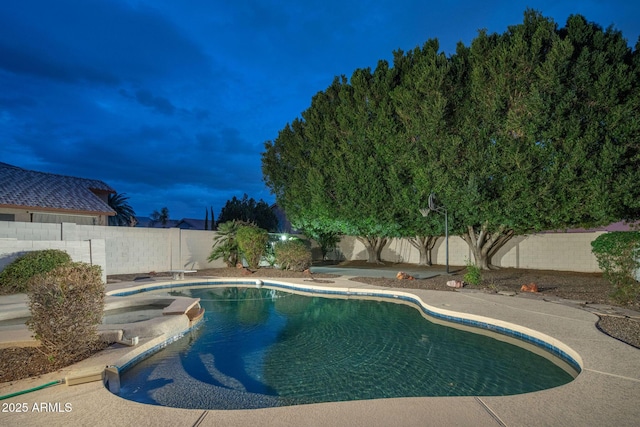 view of swimming pool with a fenced backyard, a diving board, and a fenced in pool