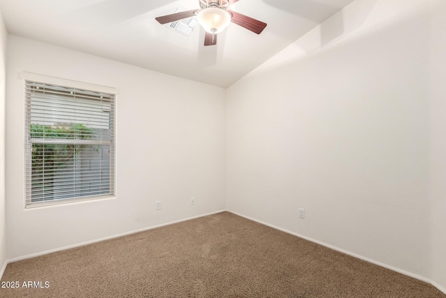 carpeted empty room with baseboards, visible vents, and ceiling fan