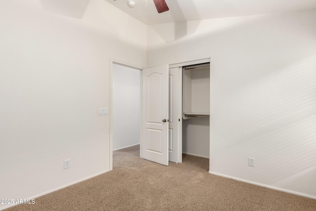 unfurnished bedroom featuring baseboards, light carpet, a closet, and ceiling fan