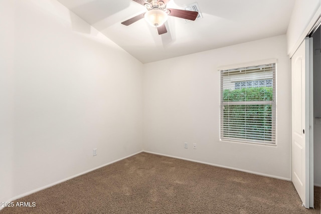 unfurnished bedroom featuring a closet, carpet flooring, ceiling fan, and visible vents