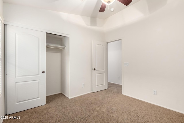 unfurnished bedroom featuring a ceiling fan, carpet, a closet, and baseboards