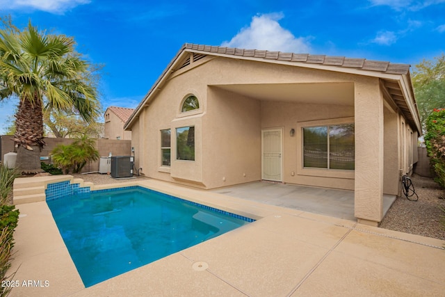 view of pool with central air condition unit, a patio, and fence