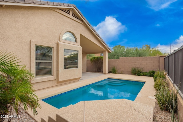 view of swimming pool featuring a fenced backyard, a fenced in pool, and a patio