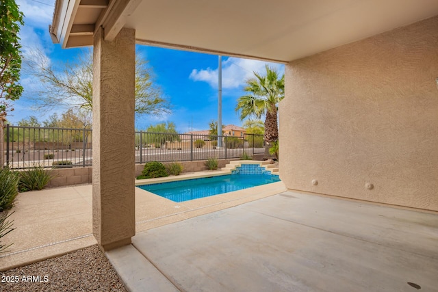 view of swimming pool with a fenced in pool, fence, and a patio area