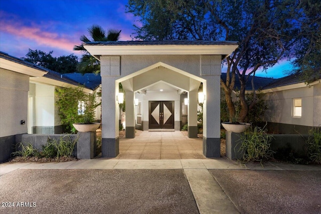 exterior entry at dusk with french doors